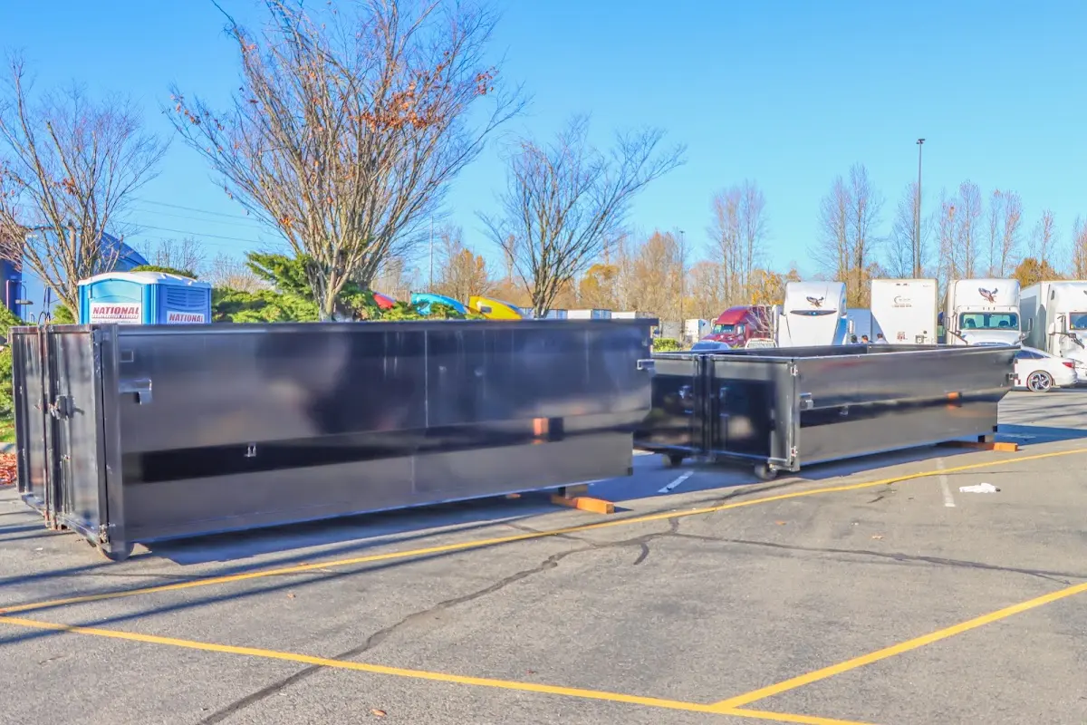 Professional dumpster rental service with roll-off container on residential driveway in Essex